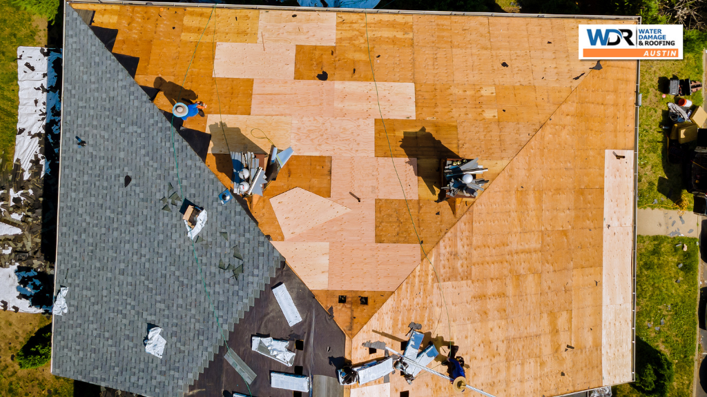 aerial view of roofing specialists on bare roof