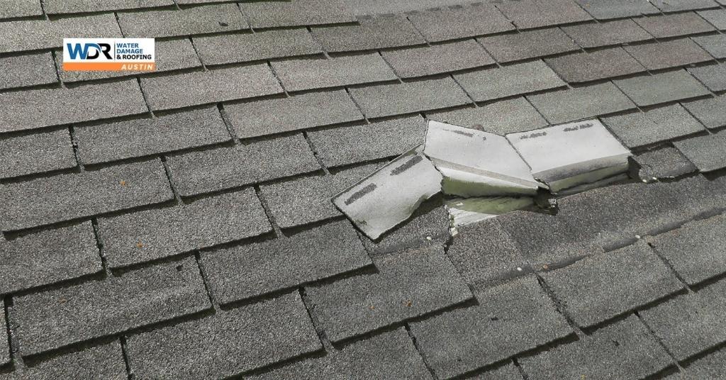 a damaged roof shingles because of a storm