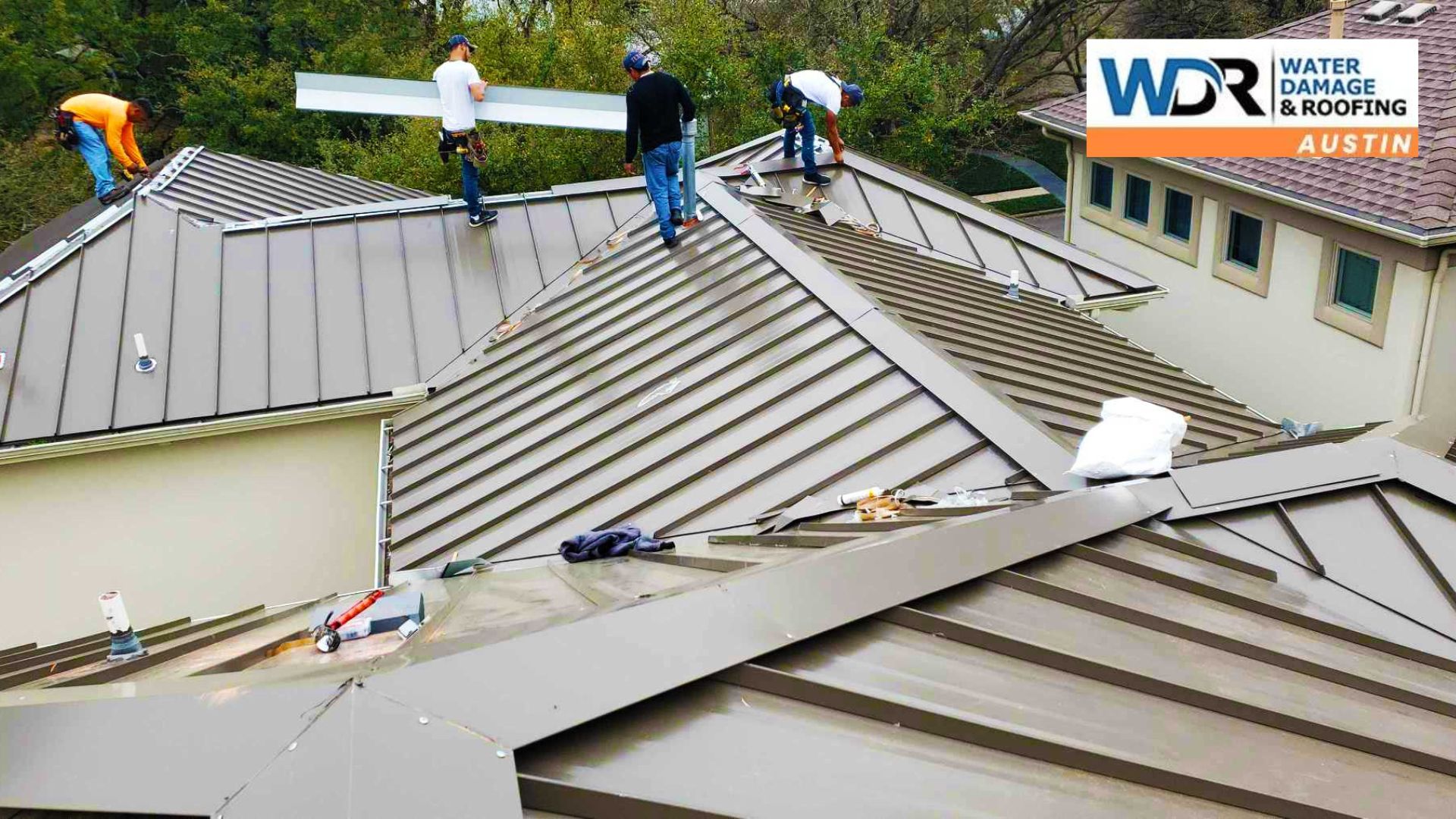 roofing contractor inspecting on residential metal roof