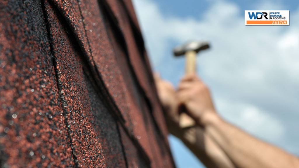 person nailing shingle roof