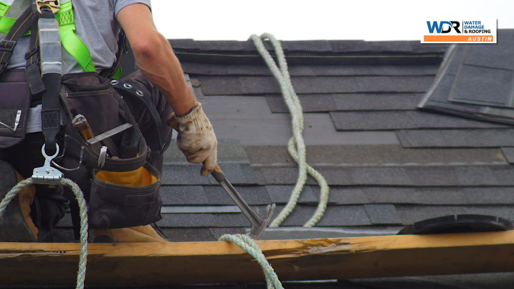 person replacing asphalt shingle