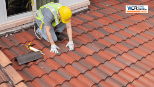 roofer inspecting a tile roof