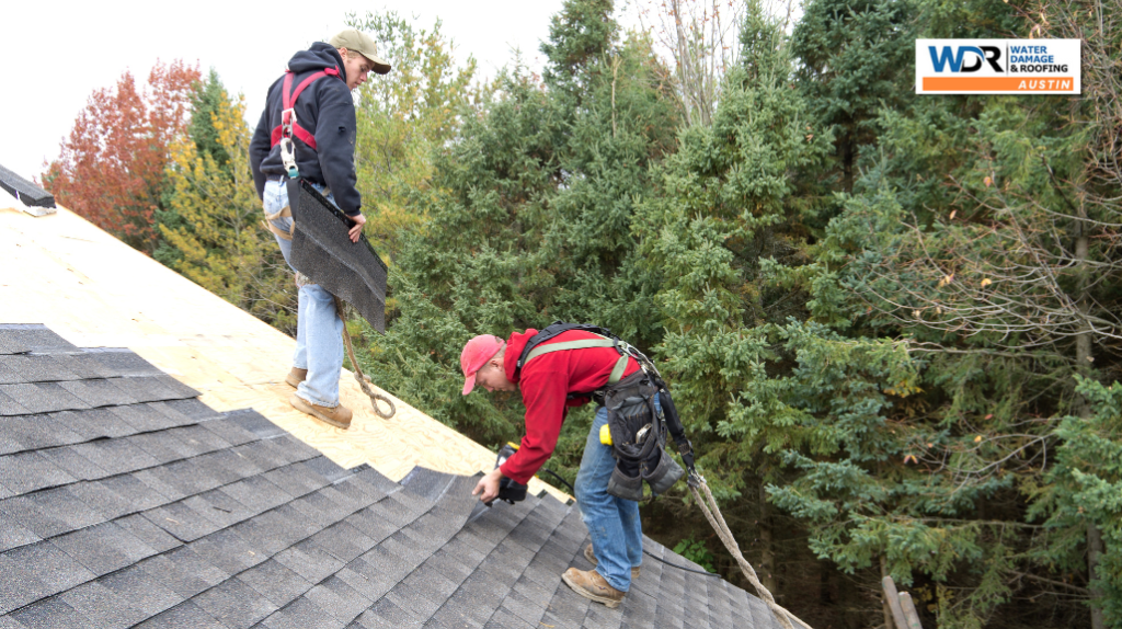 roofers replacing asphalt shingles
