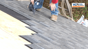 roofers installing asphalt shingle roofing